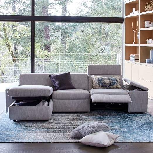 The gray sectional with its appendages raised to show the functionality of the piece