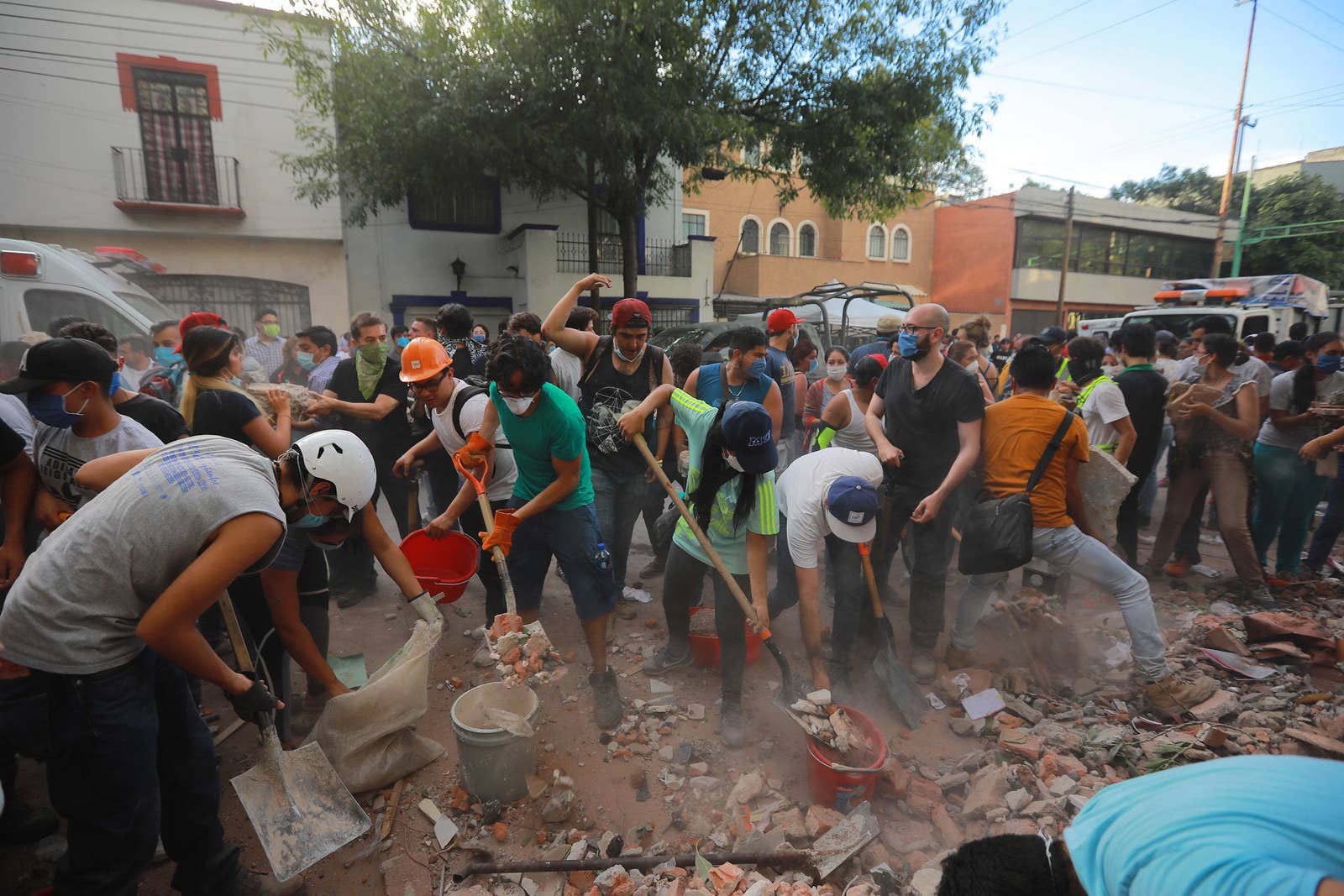 Rescuers and residents look for victims amid the ruins of a building that had been knocked down by the quake.