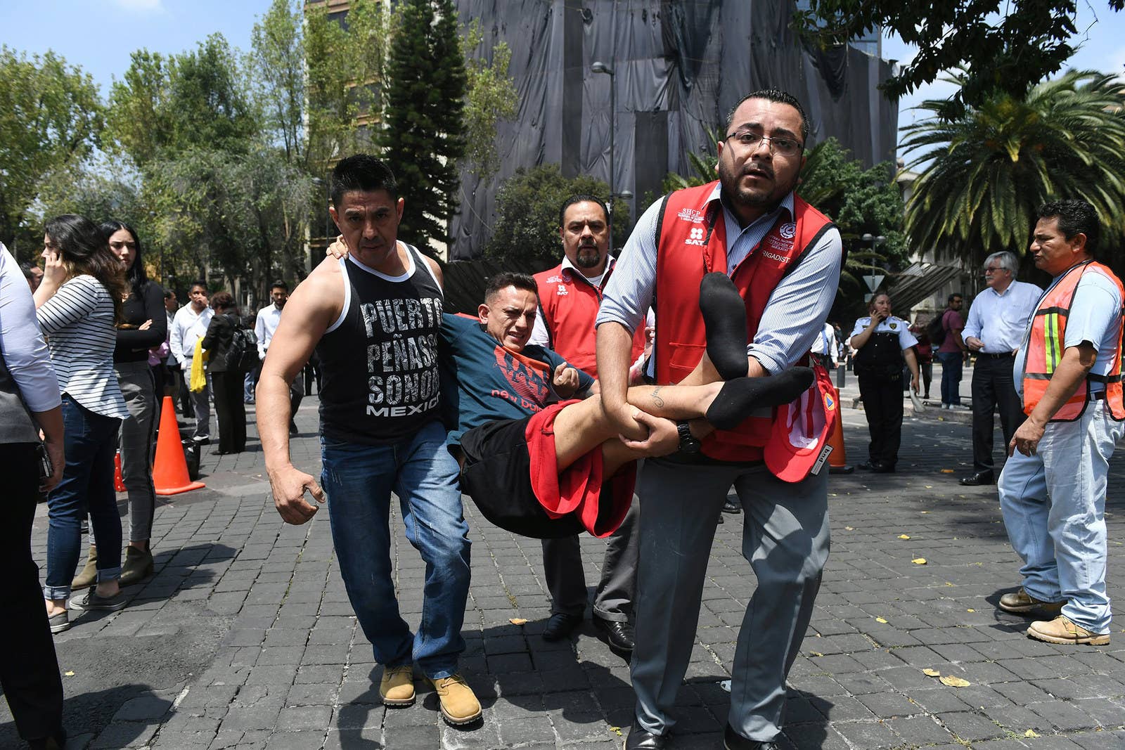 An injured man is carried away by rescuers in Mexico City.