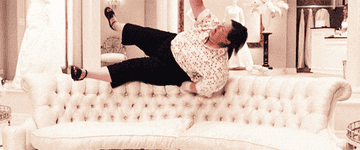 gif of Melissa McCarthy in "Bridesmaids" rolling onto a sofa