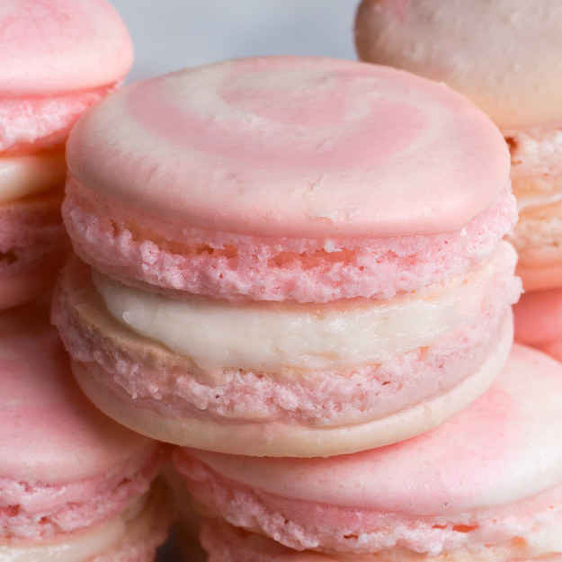 16 macaronsINGREDIENTS3 egg white, room temperature50 g (1/4 cup) sugar280 g (1 3/4 cups) powdered sugar100 g (1 cup) superfine almond flour3 drops red food coloringFilling225 g (8 oz) cream cheese, 1 package160 g (1 cup) powdered sugar2 tablespoons milk strawberry jamPREPARATION1. Preheat oven to 285ºF (140ºC).2. In a medium bowl, beat the egg whites until frothy.3. Keep beating and slowly add sugar until stiff peaks form.4. Sift powdered sugar and almond flour over the egg whites.5. Fold the dry mixture into the egg whites, giving the bowl a quarter turn every third fold. Make sure to not overmix or the macarons will not rise.6. Once the batter reaches a lava-like consistency, transfer half the batter to another bowl and add the food coloring. Mix until just combined. Do not overmix!7. Working quickly, put the white and pink batters into separate sandwich bags. Cut the corner off of each bag and squeeze the two batters evenly into a larger gallon-size bag or piping bag to create the multicolor effect.8. Pipe 1½-inch (4 cm) dollops onto a baking sheet lined with parchment paper (Tip: take a little batter to âglue:â down the edges of the parchment paper so it stays put).9. Let the cookies rest for 30 minutes to an hour, until they are no longer wet to the touch and a skin forms on top.10. While resting, make the filling by mixing the cream cheese, powdered sugar and milk in a bowl until smooth. Transfer to a piping bag and set aside until ready to fill.11. When the cookies are dry to the touch, bake for 13 to 15 minutes until they have risen to form a âfoot.â12. Let rest for 10 minutes before filling. To fill, pipe a circle of the cream cheese mixture around the edge of one cookie and place a small dollop of jam in the center. Sandwich with another macaron.13. Macarons are best kept refrigerated until serving.14. Enjoy!