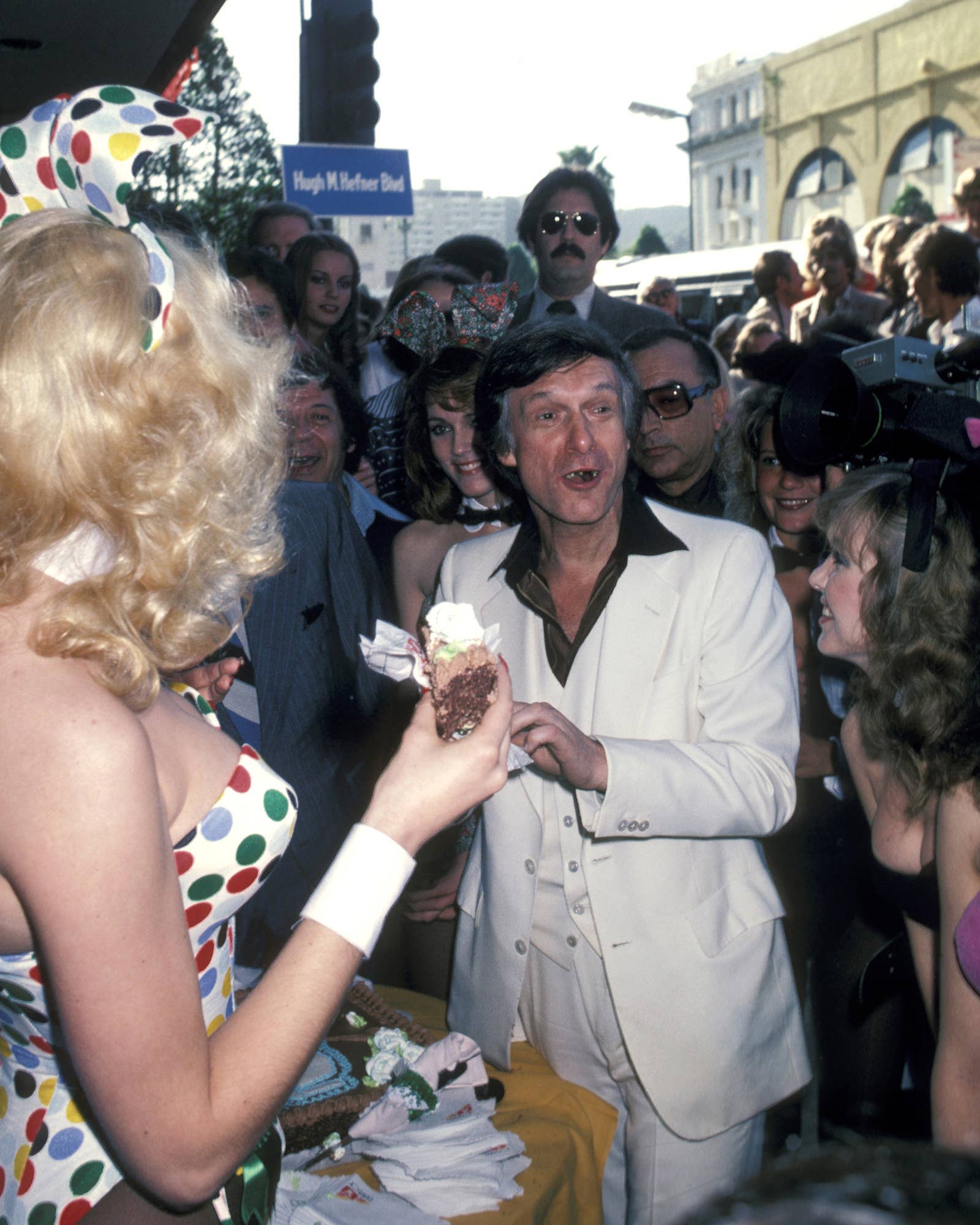 Hefner and Playboy Bunnies celebrate as he receives a star on the Hollywood Walk of Fame in 1980 for his achievements in television.