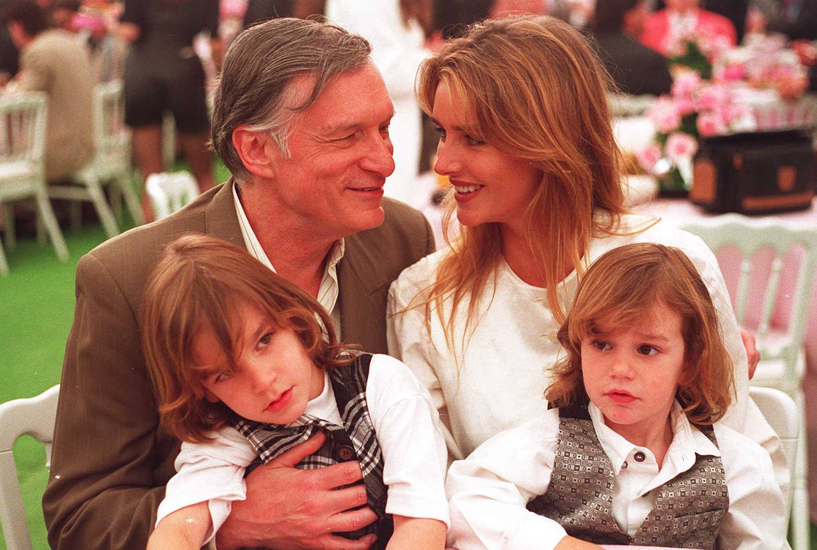 Hefner sits with his wife Kimberley and two children during an event at the Playboy Mansion in April 1994.