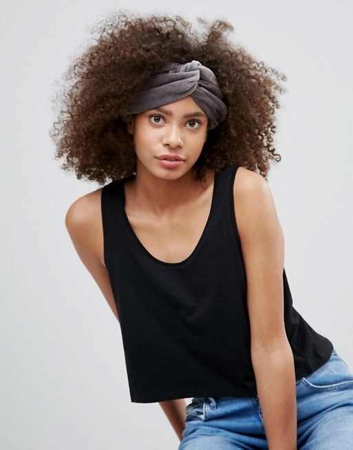 An extra-wide velvet headband with a twisted knot detail in the center for a touch of old-school glam.