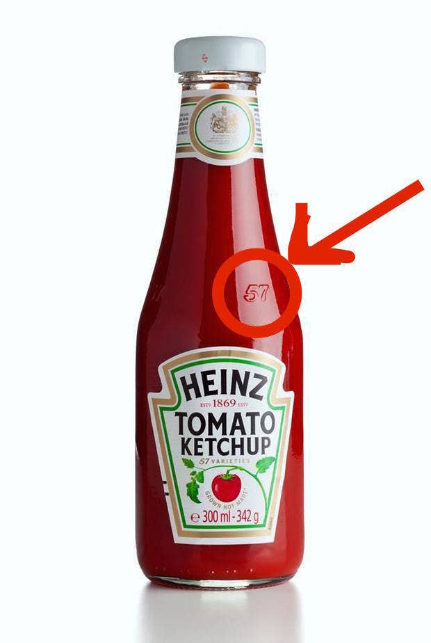 The simple reason: According to Heinz, this is the "sweet spot" on glass Heinz bottles. If you tap with your palm on that spot, then the ketchup should come out more easily. So, stop banging on the bottom of the bottle.