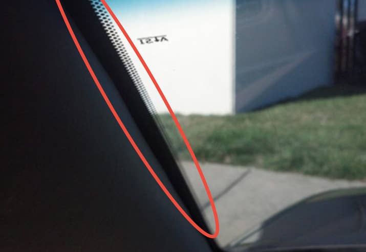 It's purpose: That black strip is called a "frit" and it essentially has two purposes. It provides an etched surface for the adhesive to adhere to, which bonds the glass to the frame. And on the outside of the glass, it protects the adhesive from ultraviolet light and covers any unsightly adhesive. The dots are there just to make it look nice.