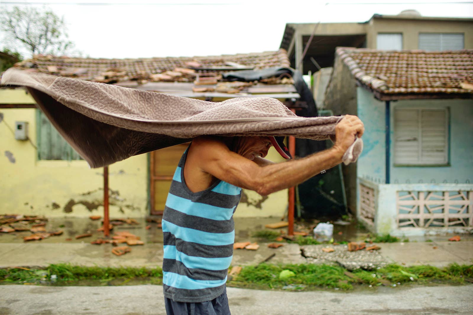 A man tries to shield himself from the rain.