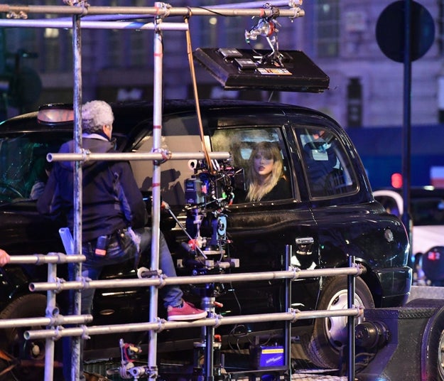 Here she is chillin' in the back of a black cab: