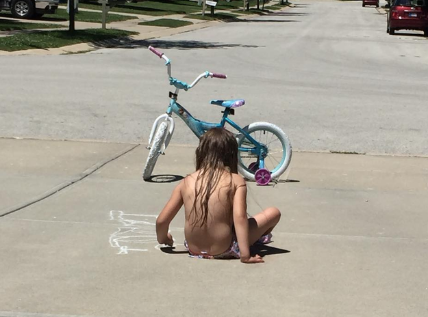 This child who decided to play sidewalk chalk half naked.