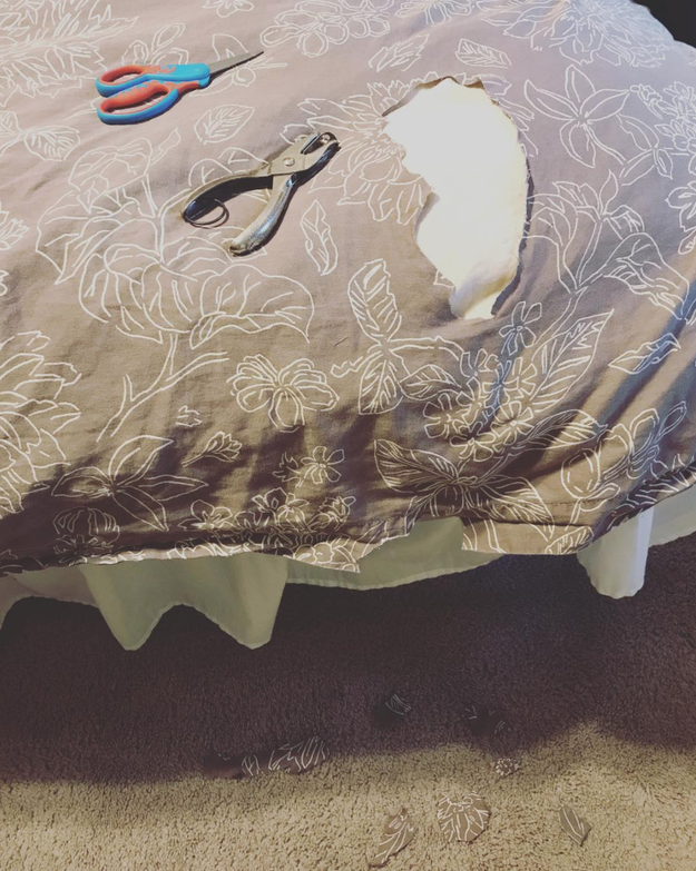 This child who decided to learn how to cut triangles on mommy's bedspread.