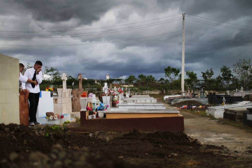 A mourner stands after the burial ceremony in Puerto Rico on Oct. 14.