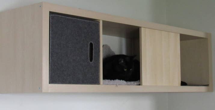 You can make a cozy little home for your cat and save some floorspace at the same time with a Kallax shelf, a fitted bin, and some soft mats. Here are the instructions.