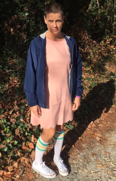 person wearing a pink dress and blue hoodie