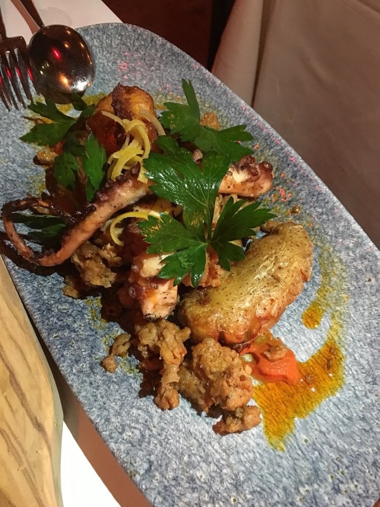An absolute "must" from the Small Plates menu, the Octopus features two plump, juicy tentacles of octopus legs over a bed of spicy merguez sausage, crispy fingerling potatoes, and smoked tomato