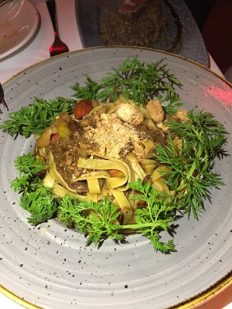 The al dente tagliatelle is prepared with rich, hearty short rib with chestnut and heirloom carrots. The pasta is topped with sweet amaretto crumble, which is an interesting addition of sweet flavor to the otherwise savory dish.