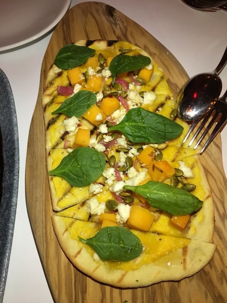 The Harvest Pumpkin is the perfect seasonal dish. The grilled flatbread is topped with cubes of butternut squash, goat cheese crumble, baby spinach, pumpkin seeds, and a drizzle of honey for a fantastic balance of sweet and savory.