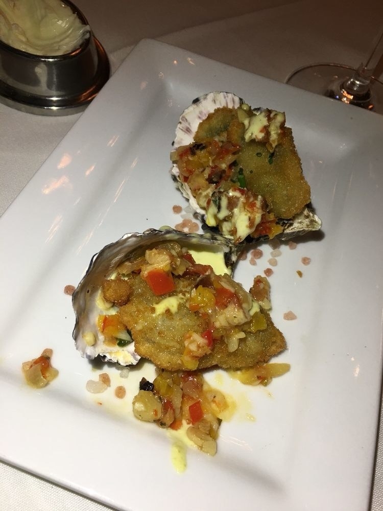 Crispy, deep-fried oyster served on the shell is topped with rich, flavorful bacon and red pepper relish and creamy tartar sauce in this perfect, bite-sized appetizer.