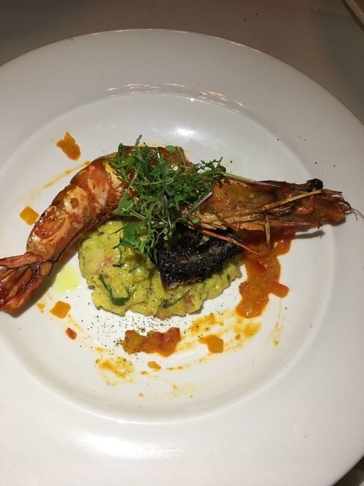 Taste the ocean in this rich risotto dish flavored with saffron. On top are perfectly grilled giant prawn and charred octopus with pepper jam on the periphery.