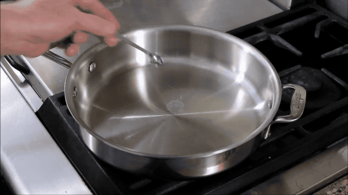 —ellap4192016f4This video says that you will know that the pan is at the perfect temperature when the water forms two beads. Carefully wipe out excess water with a dish towel before you pour in the oil. Read about the science behind this here.