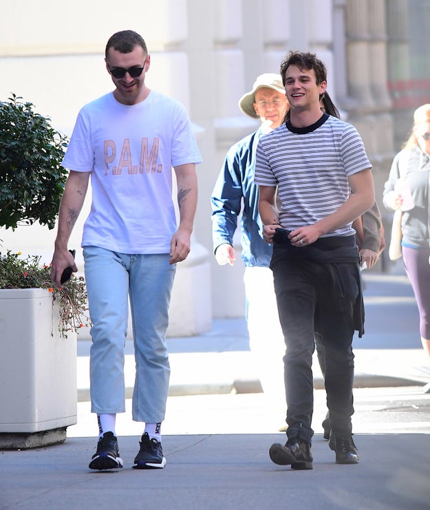 Here's awesome human being and singing legend Sam Smith walking along happily with fellow awesome human being and 13 Reasons Why actor Brandon Flynn.