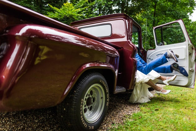 I...I don't even know anymore. I just...did the bride's dress get dirty? Are they going to show this to their children and have a good har-har over it? Either way, here's a shot of the couple canoodling in a vintage truck.