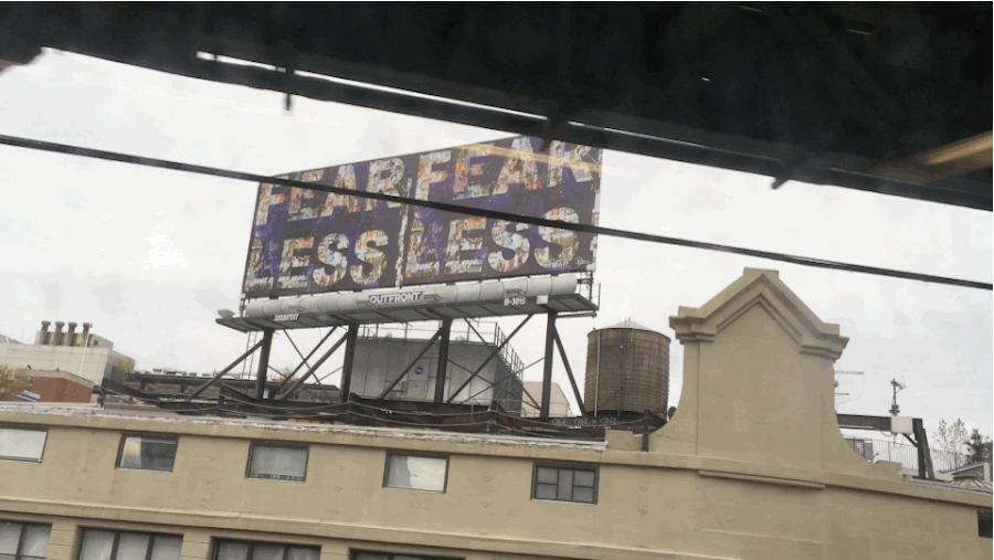 A billboard in Brooklyn, miles from the scene, reads "Fear Less."