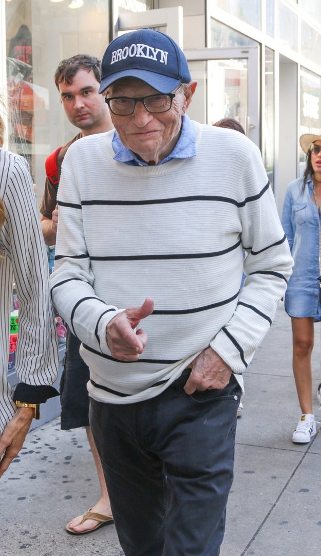 26. Larry King walking down the street