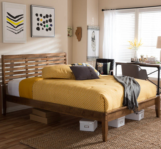 bed frame with yellow bedding and blanket
