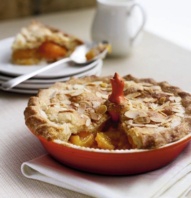 A good old-fashioned pie bird your grandma probably uses and so should you. It'll 1) prevent the filling from boiling over and creating a mess in the oven, 2) distribute moisture so the bottom doesn't get soggy, and 3) ensure the top crust cooks evenly without splitting.