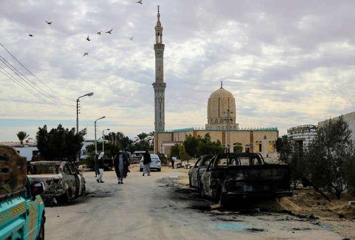 Burned-out vehicles torched by 25-30 militants during the attack are seen outside Al Rawdah mosque in Bir Al-Abed, Egypt.