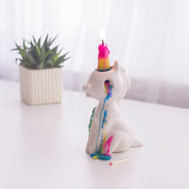 A unicorn candle holder that cries waxy, rainbow tears when you light its horn. Wow, that's dark.