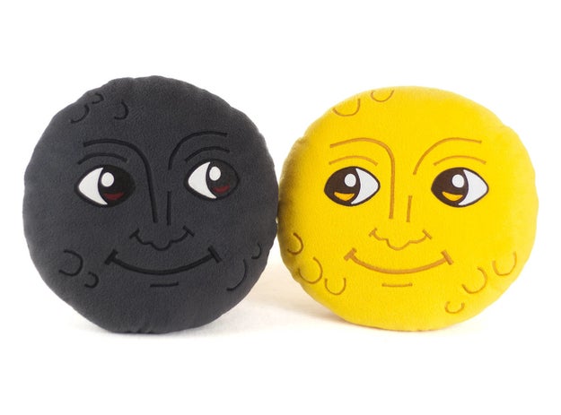 A pair of smiling moon emoji pillows because you honestly can't go a day without sending those to each other.