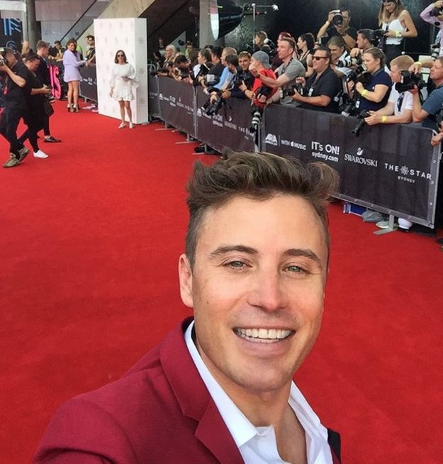 James Tobin snapped a selfie with the red carpet which was the same colour as his suit: