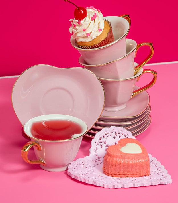 A whimsical heart-shaped tea set with a metallic trim for throwing Alice in Wonderland-themed parties.