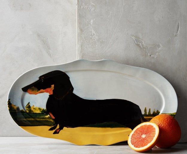 An adorable serving platter sure to be a ~weiner~ with dog lovers who entertain!