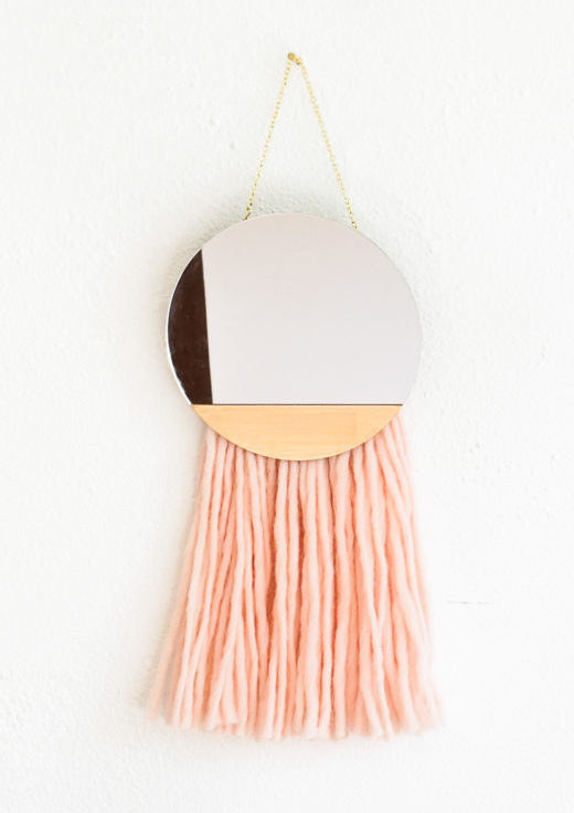 A lovely tassle-fringed mirror that will surely declare whoever looks into it to be the fairest in all the land!