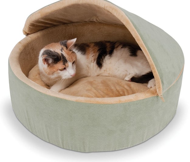 A microfleece-lined warming bed with a removable roof sure to become a cat's ~fur-vorite~ hangout spot. It's also suitable for small dogs!