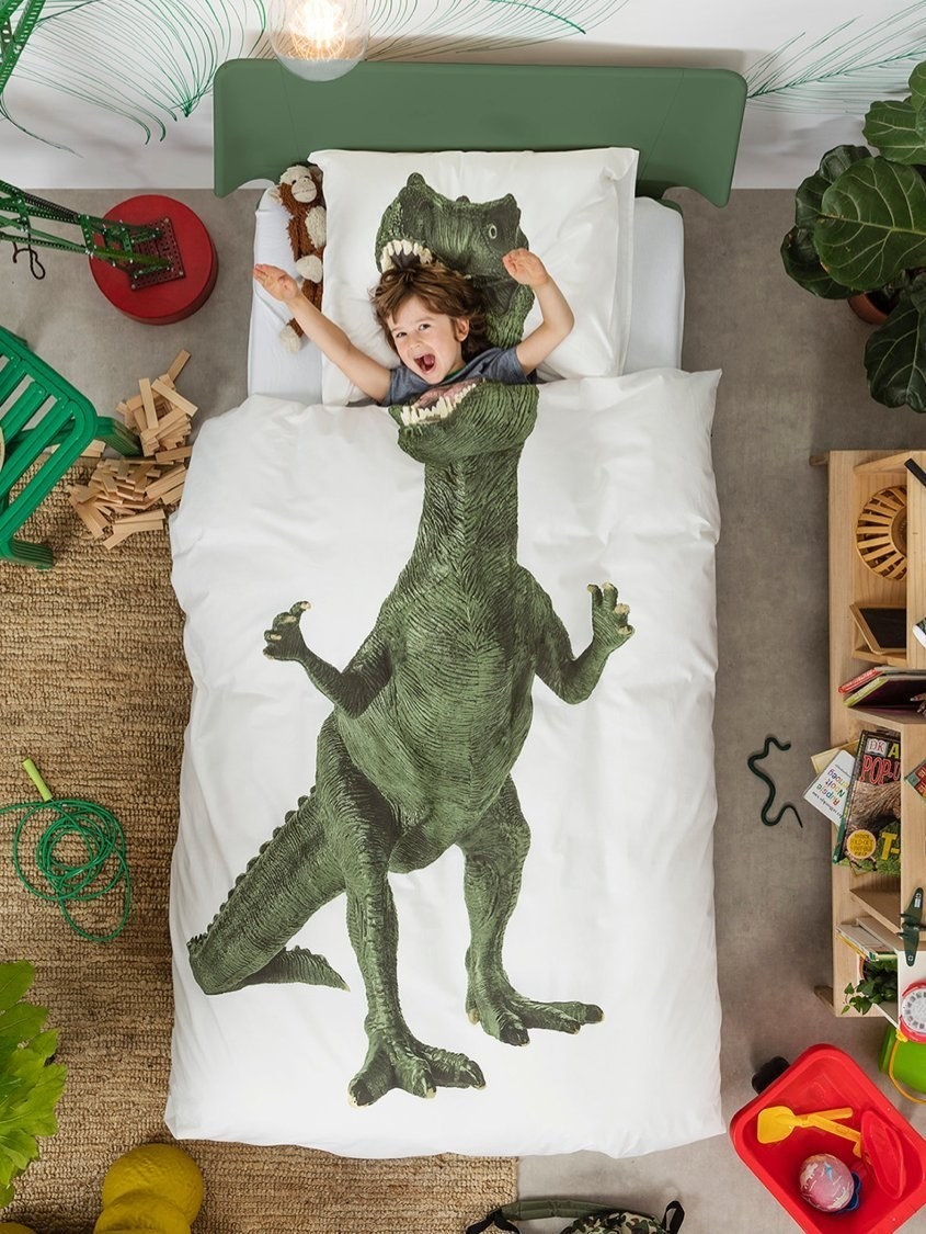 Kid in dinosaur bedspread