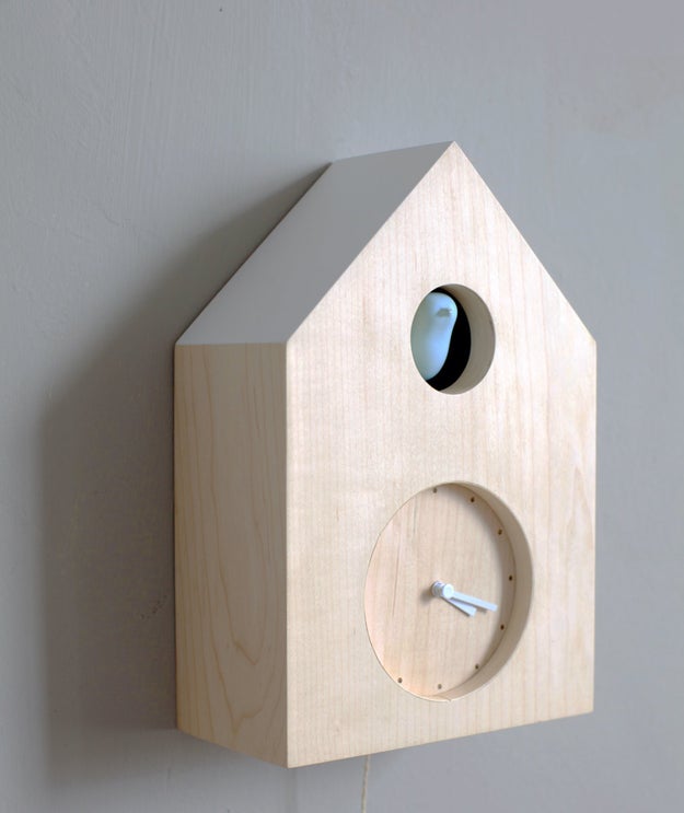 A pared-down cuckoo clock that's amusingly cat-powered.