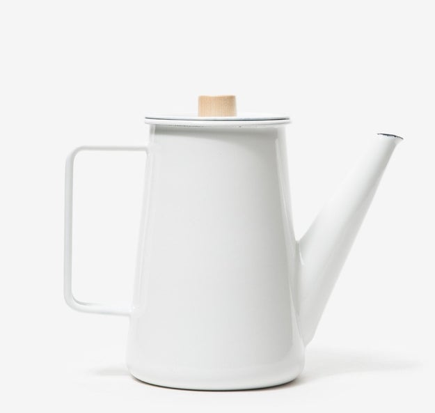 A polished coffee pot from Japan made of wood and enamel-covered steel.