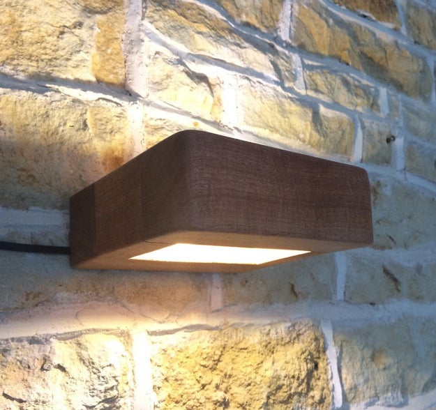 A wooden wall sconce so unassuming they'll almost forget it's there.