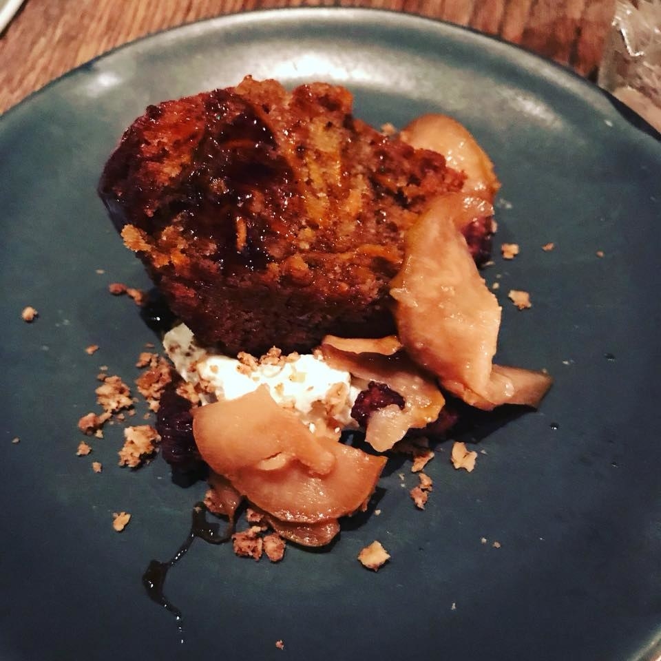 Dense yet moist piece of carrot cake resembles the taste of muffin top. The carrot cake is complemented by spiced walnuts, roasted pears, cream cheese mousse, and crunchy granola.