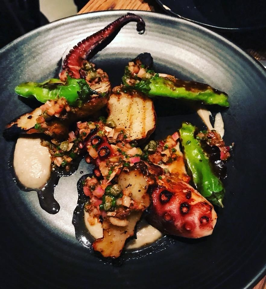 Perfectly cooked, tender piece of octopus is paired with charred shishito peppers and roasted sunchokes over a bed of creamy sunchoke puree. The octopus is seasoned with chermoula, a zesty Moroccan herb sauce.