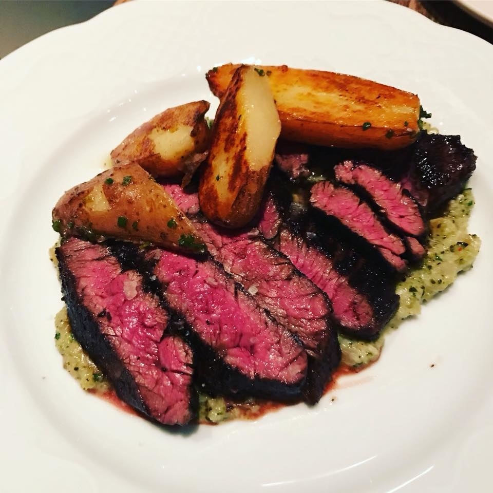 Named after a popular Chinese takeout dish, Beef & Broccoli highlights charred slices of medium-red skirt steak simply seasoned with sea salt. The steak is paired with a dollop of whipped broccoli, béchamel, cheddar and black garlic and duck fat-cooked crispy potatoes.