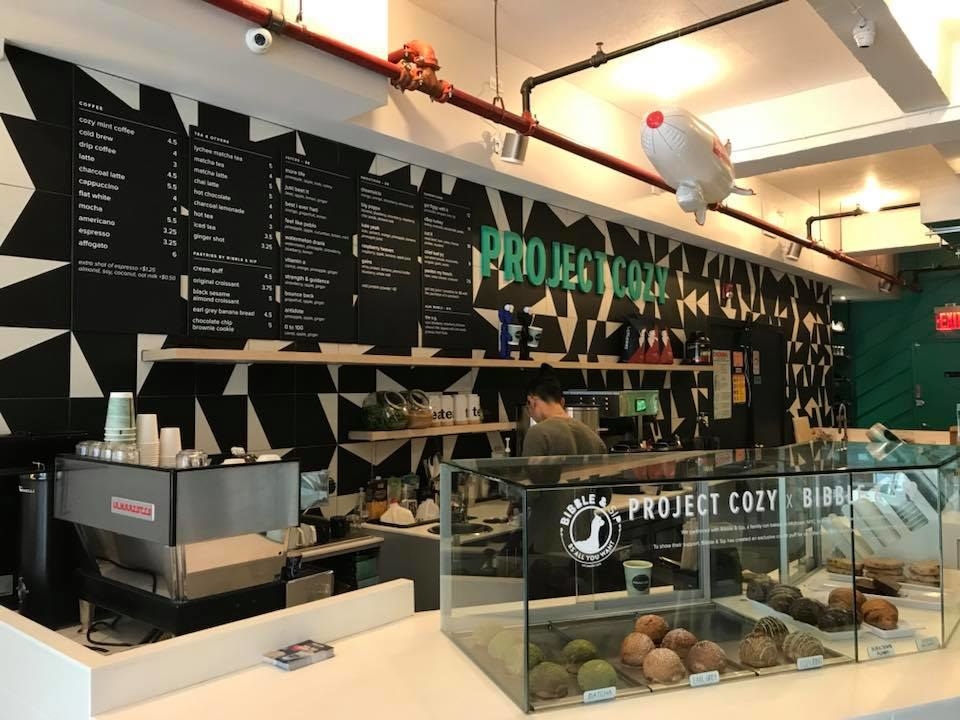 Opened in July 2017, Project Cozy in New York City's Nolita neighborhood serves everything from coffee & tea (the specialty drinks are the Cozy Mint Coffee and Charcoal Latte) to fresh juices and smoothies to pastries by Bibble & Sip, a renowned bakery in Midtown. Project Cozy recently expanded its menu to feature made-to-order sandwiches. Here are some of our favorites!