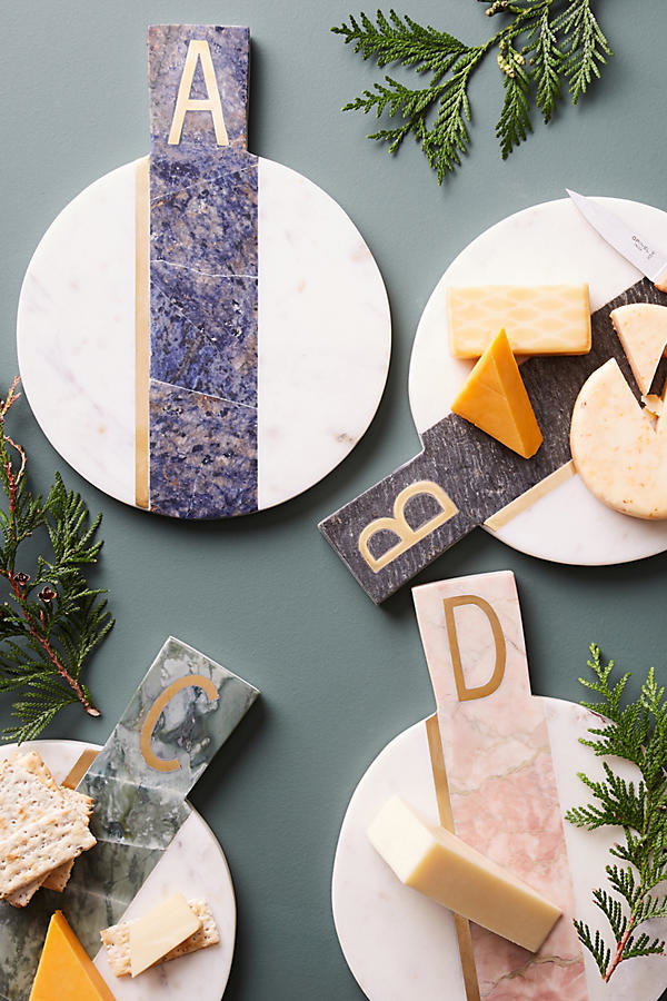 A marble cheese board as a place to park your night cheese before devouring it.