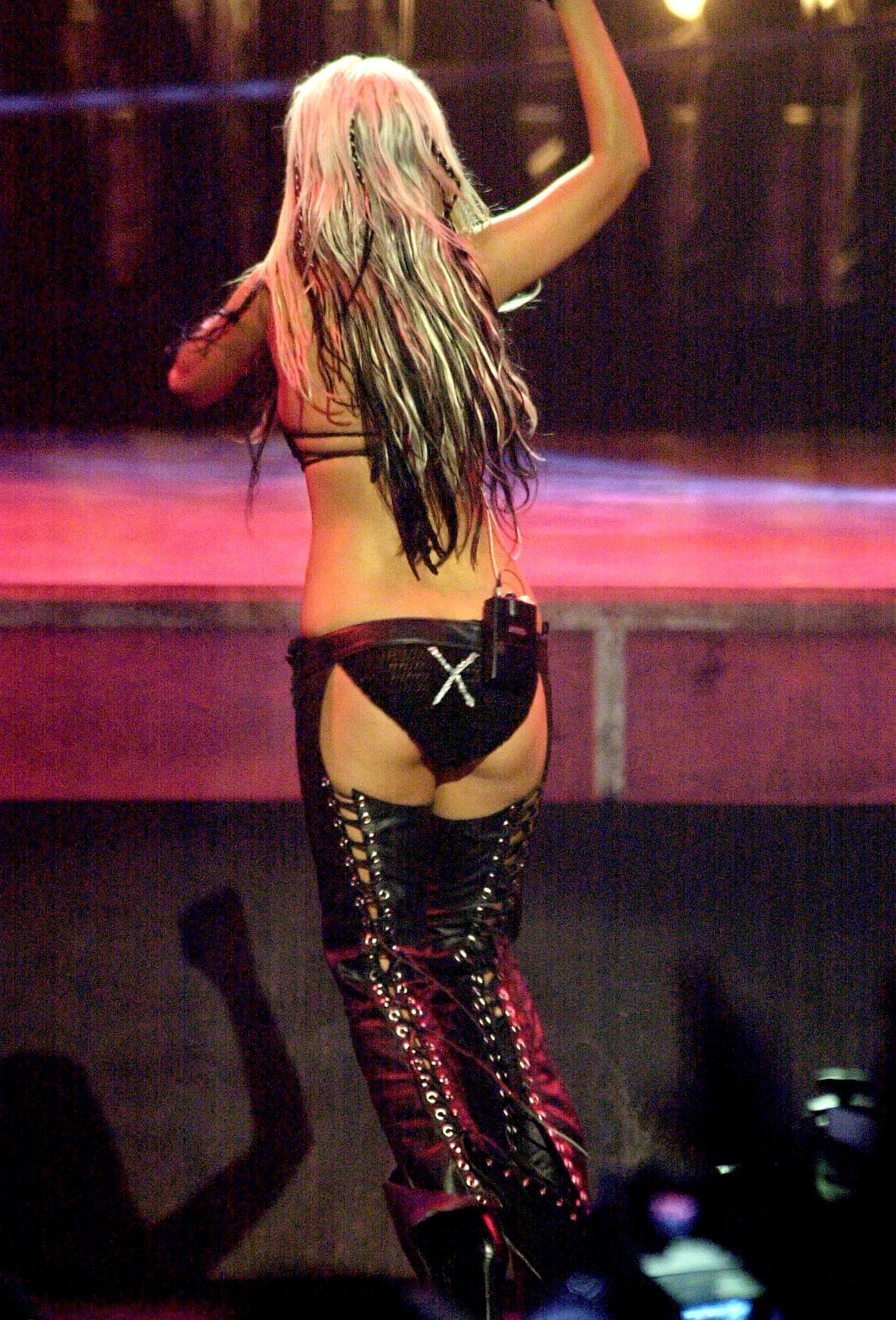 Christina onstage wearing black leather chaps