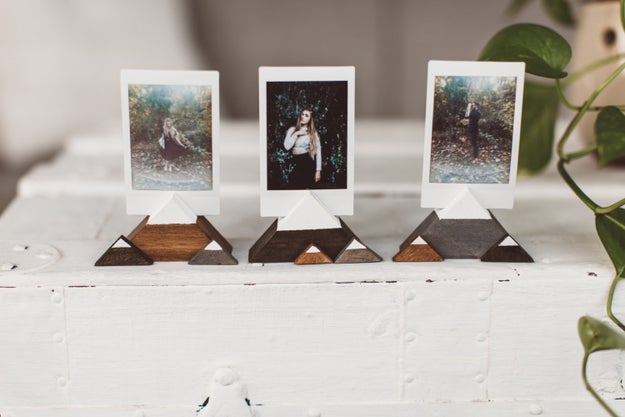 A set of wooden mountains to hold up a few of their favorite photos — probably all taken on actual mountains.