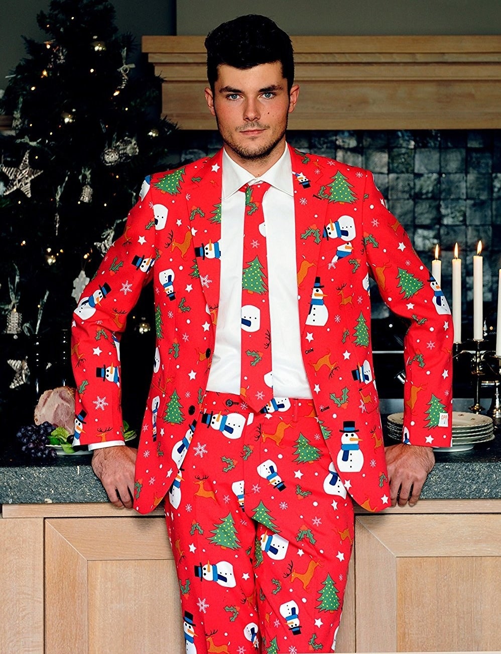 Man in red suit with snowmen, Christmas trees, stars, holly, and reindeer printed on it