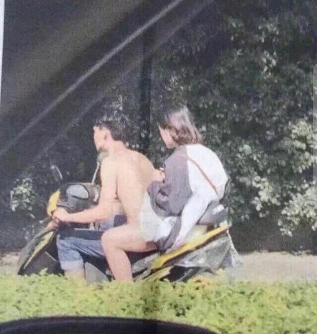 This naked man riding a motorcycle.